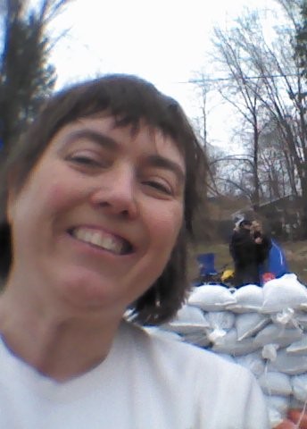 photo of Louise in front of wall of sandbags