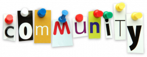 A stylized image of individual letters as though they were cut out of a magazine (different fonts and colours on differently coloured backgrounds). The letters are tacked up to spell out the word "community"