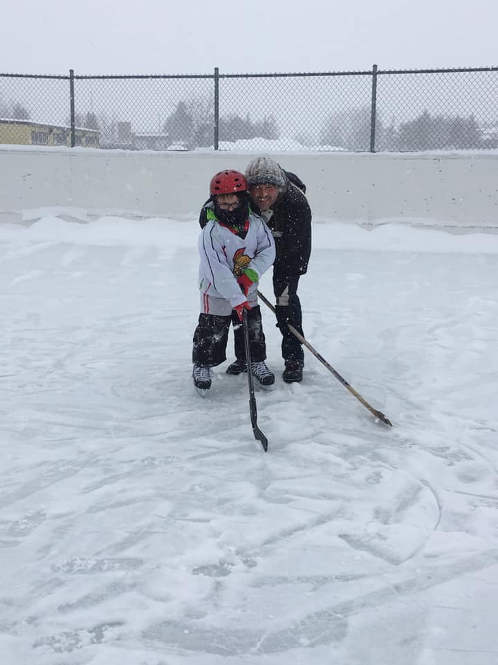 father and son on ice rink