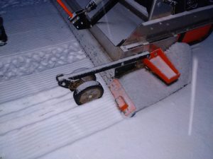 close up image of grooming machine grooming the snow