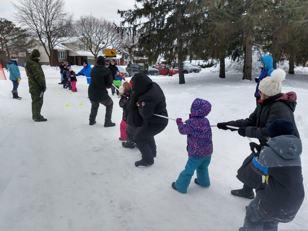 people playing tug of war (photo taken pre-pandemic)