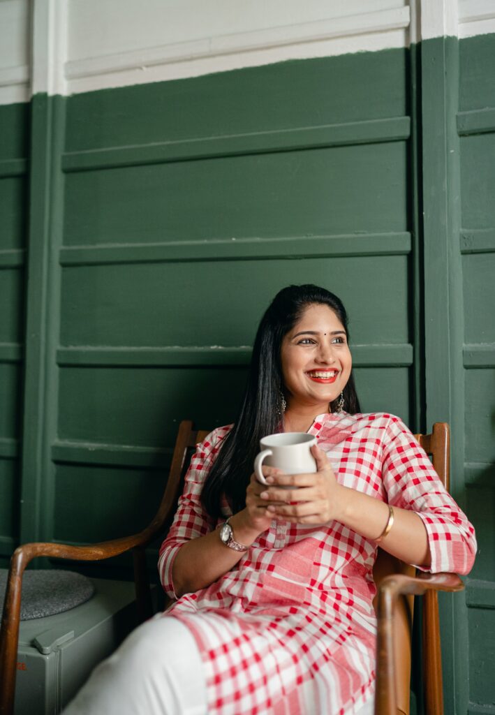 woman holding a tea and smiling