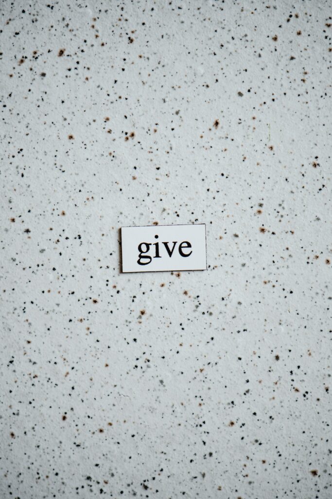 the word "give" on a white speckled background