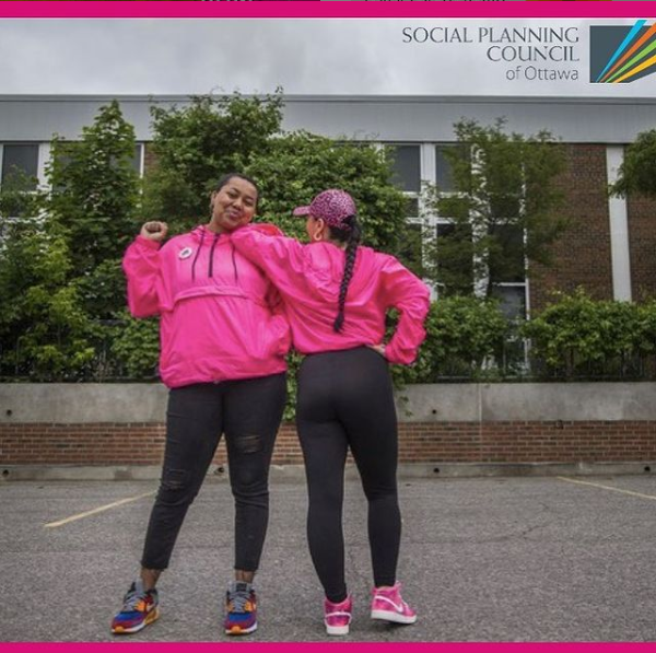 picture of Hit the Streets founders in bright pink jackets.