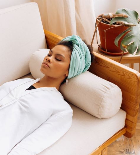 woman lying down and relaxing on a sofa.