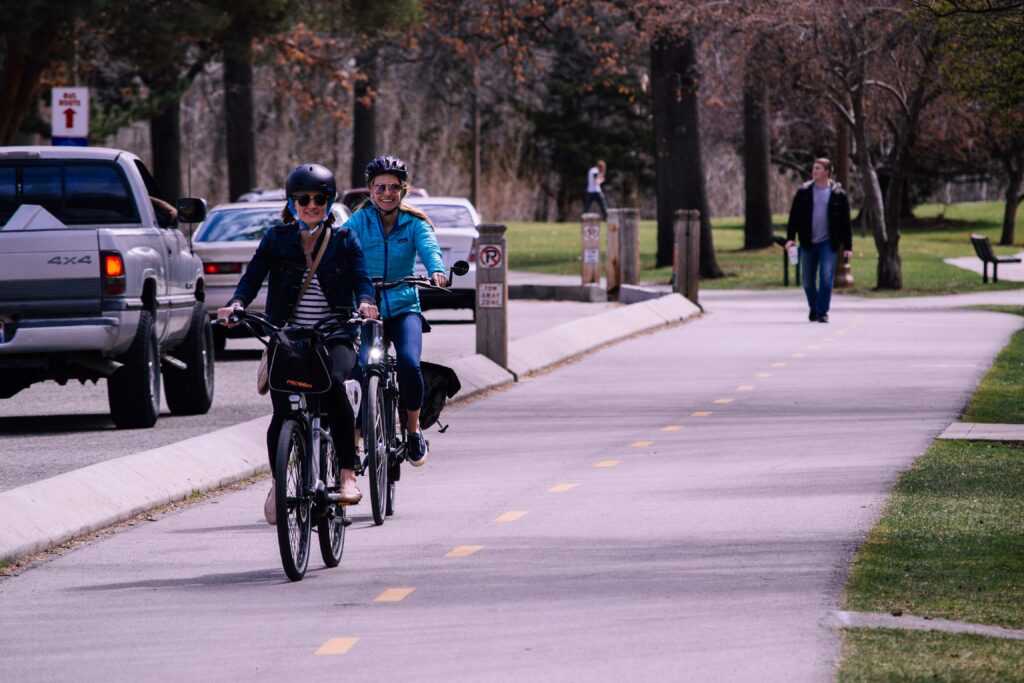 two people cycling on a protected bike lane