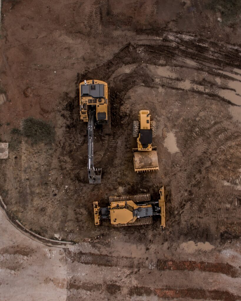 aerial image of construction vehicles on a dirt surface