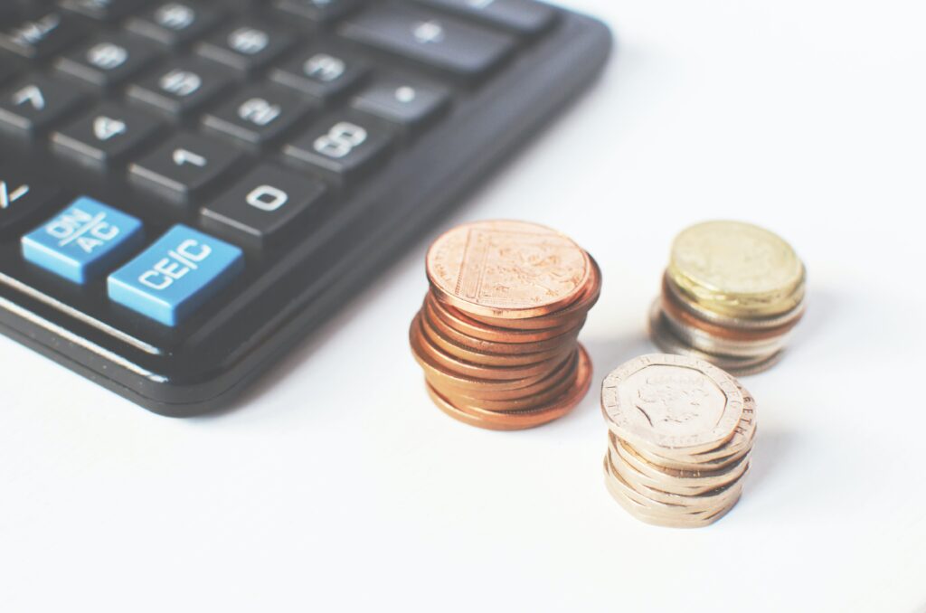 image of a calculator with stacks of coins