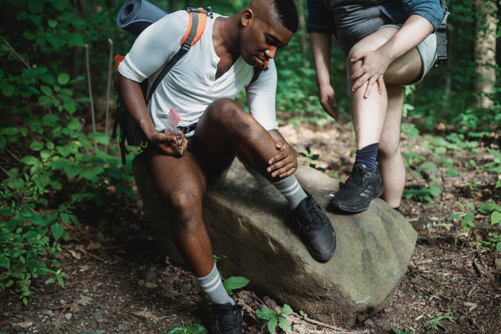 photo of two hikers checking their skin for ticks